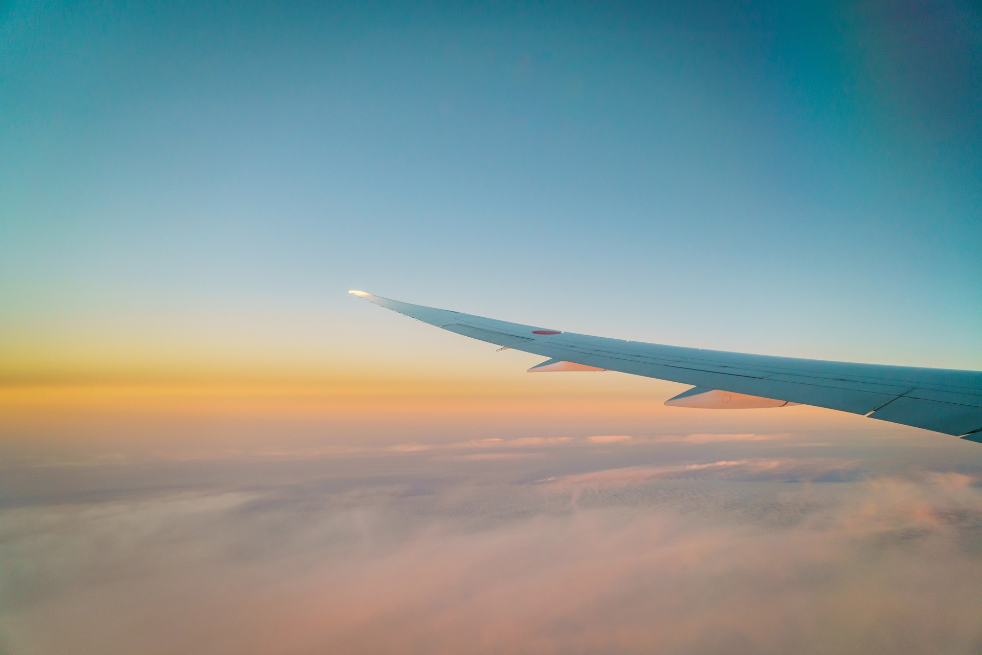 wing-airplane-flying-clouds-1250